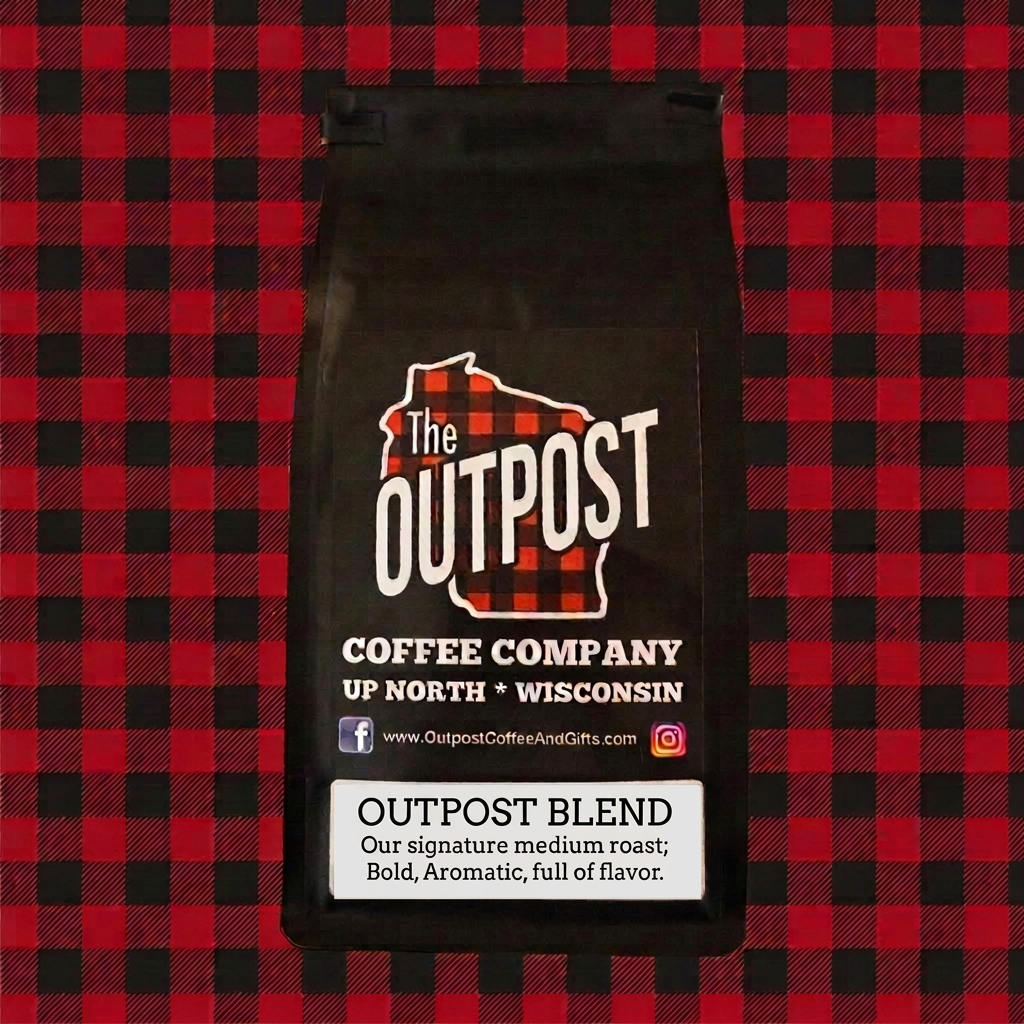 Outpost Blend black coffee bag with a crisp white label on red and black plaid