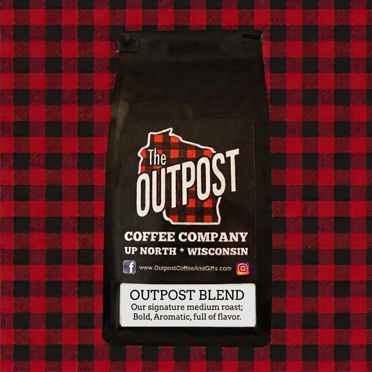Outpost Blend black coffee bag with a crisp white label on red and black plaid